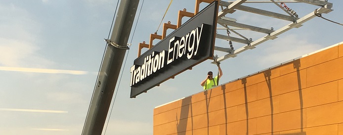 Tradition energy sign being installed by construction worker,
